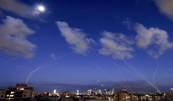 This long exposure shows trails and explosions from projectile interceptions by Israel's Iron Dome missile defence system over Tel Aviv on February 28, 2026. The United States and Israel launched strikes against Iran on February 28, with Israel's public broadcaster reporting that the Iranian supreme leader had been targeted, as the Islamic republic retaliated with barrages of missiles at Gulf states and Israel. (Photo by JACK GUEZ / AFP)
