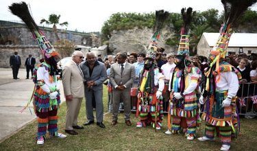 Britain's King Charles III greets Gombey dancers during a cultural welcome at the Royal Naval Dockyard, Sandys Parish, Bermuda on May 1, 2026. King Charles III is in Bermuda for his first visit to a British Overseas Territory as Sovereign. (Photo by HENRY NICHOLLS / AFP)