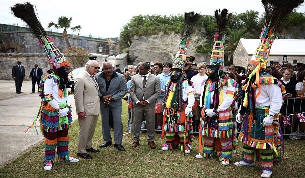 Britain's King Charles III greets Gombey dancers during a cultural welcome at the Royal Naval Dockyard, Sandys Parish, Bermuda on May 1, 2026. King Charles III is in Bermuda for his first visit to a British Overseas Territory as Sovereign. (Photo by HENRY NICHOLLS / AFP)