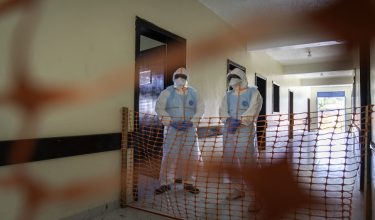 Health workers stand in a new Ebola treatment center during a visit of Tedros Adhanom Ghebreyesus, Director-General of the World Health Organization (WHO), in Bunia, in the northeastern Democratic Republic of the Congo, on May 31, 2026. The World Health Organization's director general had earlier announced he was coming to Bunia, capital of Ituri province, to "help" and "listen to" the people facing the worst of the outbreak.The highly contagious haemorrhagic fever is already present in three eastern DRC provinces and in neighbouring Uganda, where nine confirmed infections, including one death, have been recorded.There have been at least 1,077 suspected cases of Ebola in the DRC since the outbreak was declared on May 15, including 246 deaths, the Africa Centres for Disease Control and Prevention said on May 28. (Photo by GLODY MURHABAZI / AFP)