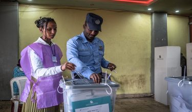 An Ethiopian police officer casts his ballot at a polling station in Kechene, Addis Ababa, on June 1, 2026 during the 2026 Ethiopian parliamentary elections. Ethiopians began voting on June 1, 2026 in parliamentary elections, with the party of outgoing Prime Minister Abiy Ahmed, who is running for another term, expected to win. 
Around 50 million voters are eligible to vote in the election for members of parliament, who will in turn select the prime minister. (Photo by Marco Simoncelli / AFP)