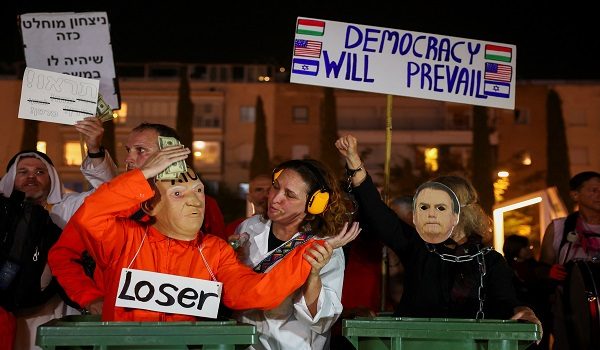 People wear masks of Israeli Prime Minister Benjamin Netanyahu and former Brazilian President Jair Bolsonaro, as Israelis protest against Netanyahu and his government in Tel Aviv, Israel, April 25, 2026. REUTERS/Florion Goga