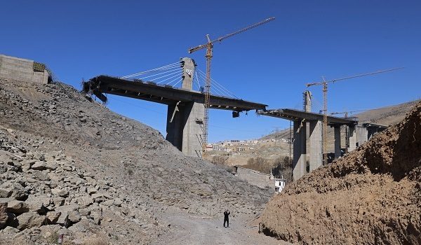 A man takes pictures with his mobile phone of the B1 bridge, a day after it was destroyed by a strike in Karaj, around 20miles (35kms) southwest of Tehran, April 3, 2026. US President Donald Trump said on April 2 the tallest bridge in Iran had been destroyed, hours after threatening to bomb the country "back to the Stone Ages." (Photo by ATTA KENARE / AFP) /