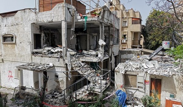 This aerial photograph shows the damaged building that was hit by an Iranian strike in a residential neighbourhood in Ramat Gan on April 4, 2026. The Israeli army said on April 4 its air defences were working to down missiles fired from Iran, which medics reported wounded one person. (Photo by Jack GUEZ / AFP) /