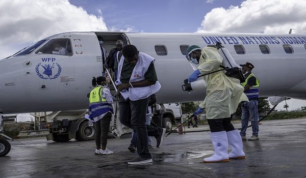 A health worker decontaminates a passenger's shoes at Bunia Airport in eastern Democratic Republic of the Congo on June 3, 2026. On May 23, DRC authorities announced the temporary closure of Bunia Airport, located in the capital of Ituri Province, where the 17th Ebola outbreak is raging. The airport reopened on June 2. To date, 48 deaths have been reported among 321 confirmed cases of infection, according to Congolese health authorities and the WHO. (Photo by GLODY MURHABAZI / AFP)