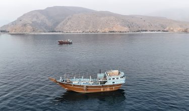This aerial photograph shows boats anchored off Omans northern Musandam Peninsula near the Strait of Hormuz on June 27, 2026. Iran launched attacks on US sites in the Gulf in response to American strikes on the country, state media said on June 27, after Washington accused Tehran of attacking one of its cargo ships in the Strait of Hormuz. The trading of fire raised questions about efforts to keep the crucial waterway open while Washington and Tehran negotiate a final settlement to a war that began on February 28 with US and Israeli strikes on Iran. (Photo by AFP) /