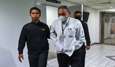 Tertuduh (kanan) mengaku tidak bersalah di Mahkamah Sesyen hari ini atas 24 tuduhan menyalahgunakan kuasa dengan memberikan perolehan membaiki kenderaan jabatan kepada syarikat milik isterinya, dua tahun lalu./ BERNAMA