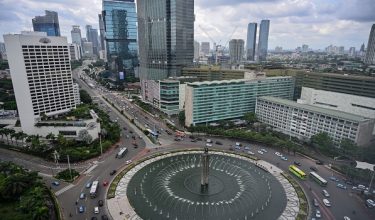 Buildings are seen by the landmark Hotel Indonesia roundabout in Jakarta on January 30, 2019. (Photo by BAY ISMOYO / AFP)