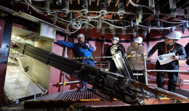 A robotic arm demonstrates the removal of melted nuclear fuel debris during a simulation at the Fukushima Daiichi Nuclear Power Plant, operated by Tokyo Electric Power Company, in Naraha Town, Fukushima Prefecture on February 25, 2026. (Photo by JAPAN POOL / JIJI PRESS / AFP) / Japan OUT / JAPAN OUT