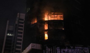 Flames engulf a building after an Iranian strike in the capital Manama on February 28, 2026. The United States and Israel launched waves of strikes on February 28 against targets in Iran, sparking swift retaliation by the Islamic republic which responded with missile attacks across the region. (Photo by Fadhel MADAN / AFP)
