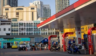 Motorcyclists queue up at a petrol station in Bangkok on February 22, 2023. (Photo by Jack TAYLOR / AFP)