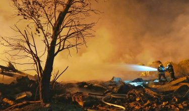 Firefighters spray water at the scene of a fireworks factory explosion in Liuyang, in Chinas central Hunan province early on May 5, 2026. A giant explosion at a fireworks factory in central China killed at least 21 people and injured 61, state media said on May 5. The explosion occurred at around 4:43 pm on May 4 at the Liuyang Huasheng Fireworks Manufacturing and Display Company in Liuyang, Hunan province, state broadcaster CCTV said. (Photo by CNS / AFP) / China OUT