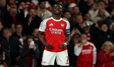 Arsenal's English midfielder #07 Bukayo Saka celebrates scoring the team's first goal during the UEFA Champions League second-leg semi-final football match between Arsenal and Atletico Madrid at the Emirates Stadium in north London on May 5, 2026. (Photo by Adrian Dennis / AFP)