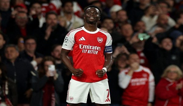 Arsenal's English midfielder #07 Bukayo Saka celebrates scoring the team's first goal during the UEFA Champions League second-leg semi-final football match between Arsenal and Atletico Madrid at the Emirates Stadium in north London on May 5, 2026. (Photo by Adrian Dennis / AFP)