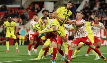 Girona's Ukrainian midfielder #15 Viktor Tsygankov (R) pushes Villarreal's Spanish midfielder #14 Santi Comesana as he kicks the ball during the Spanish league football match between Girona FC and Villarreal CF at Montilivi Stadium in Girona on April 6, 2026. (Photo by Lluis GENE / AFP)