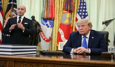 US President Donald Trump looks on as White House Deputy Chief of Staff Stephen Miller (L) speaks about birth rights in the Oval Office of the White House in Washington, DC, on August 6, 2026. (Photo by Jim WATSON / AFP) / The erroneous mention[s] appearing in the metadata of this photo by Jim WATSON has been modified in AFP systems in the following manner: [August 6] instead of [August 7]. Please immediately remove the erroneous mention[s] from all your online services and delete it (them) from your servers. If you have been authorized by AFP to distribute it (them) to third parties, please ensure that the same actions are carried out by them. Failure to promptly comply with these instructions will entail liability on your part for any continued or post notification usage. Therefore we thank you very much for all your attention and prompt action. We are sorry for the inconvenience this notification may cause and remain at your disposal for any further information you may require.