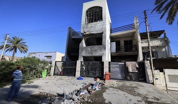 A man assesses the damage after a house was partially destroyed by a projectile the previous evening in the Amiriya district of western Baghdad, on April 8, 2026. Projectiles killed an eight-year-old child and at least six other people in Iraq, officials said on April 7, shortly before the United States and Iran agreed to a two-week ceasefire. Two people, including the eight-year-old child, were killed late on April 7 in Baghdad when a projectile crashed into their home, causing a fire, a police source told AFP. (Photo by AHMAD AL-RUBAYE / AFP)