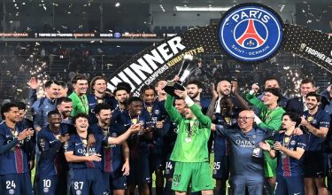 PSG's players celebrate with the trophy after winning the French Champions' Trophy (Trophee des Champions) football match between Paris Saint-Germain (PSG) and Olympique de Marseille (OM) at the Jaber Al-Ahmad International Stadium in Kuwait City on January 8, 2026. (Photo by YASSER AL-ZAYYAT / AFP)