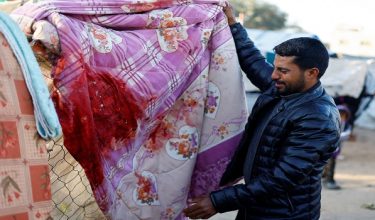 A relative of Palestinians killed in an Israeli strike on a tent sheltering displaced people, reacts at the site of the strike in Nuseirat, central Gaza Strip March 9, 2026. REUTERS/Mahmoud Issa