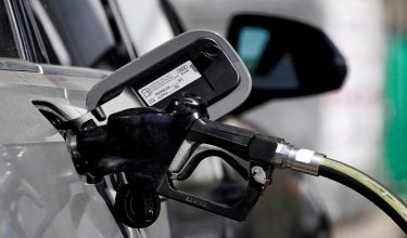 FILE PHOTO: A gas pump is inserted inside an Audi vehicle at a Mobil gas station in Beverly Boulevard in West Hollywood, California, U.S., March 10, 2022. Picture taken March 10, 2022. REUTERS/Bing Guan/File Photo