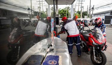 A worker fills up a motorcycle at a gas station as oil prices are expected to increase amid the U.S.-Israel conflict with Iran, in Quezon City, Metro Manila, Philippines, March 9, 2026. REUTERS/Lisa Marie David