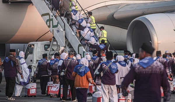 A number of Indonesian Muslim pilgrims prepare to board a passenger plane before heading to the holy city of Mecca to perform the annual hajj pilgrimage at Sultan Mahmud Badaruddin II International Airport in Palembang, Indonesia, on May 3, 2025. Hajj is a form of worship in which the world's Muslims who have the financial and physical means visit the holy places of worship in Saudi Arabia and perform their worship. Indonesia receives a quota of 221,000 pilgrims consisting of 203,320 regular Hajj pilgrims and 17,680 special Hajj pilgrims. (Photo by Muhammad Fajri/NurPhoto)NO USE FRANCE