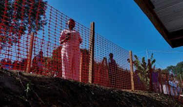 People look through a safety cordon red-line at the Evangelical Medical Center (CEM), one of the facilities at the forefront of the response to the Ebola outbreak, as agencies intensify efforts to contain a new Ebola outbreak caused by the Bundibugyo virus strain, in Bunia, Ituri province, Democratic Republic of Congo, May 31, 2026. REUTERS/Gradel Muyisa Mumbere