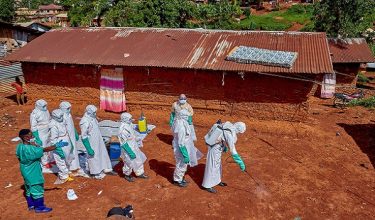FILE PHOTO: Red Cross workers wearing personal protective equipment walk in a formation as they disinfect the ground outside the house of an unidentified man who died of Ebola, before retrieving his body, as aid agencies intensify efforts to contain a new Ebola outbreak involving the Bundibugyo strain, in Quartier Shuni 1, a residential sector in Mongbwalu, Djugu Territory of Ituri province, Democratic Republic of Congo, May 24, 2026. REUTERS/Gradel Muyisa Mumbere/File Photo