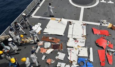 This handout photograph taken on July 8, 2026 and released by the Pakistan Airports Authority shows Pakistan Navy and Pakistan Maritime Security Agency personnel standing next to the wreckage of the K2 Airways Cargo Boeing 737, after it was recovered during a search and rescue operation in the Arabian Sea, off Ormara town. Pakistan located the wreckage of a Boeing cargo plane on July 8, the country's airports authority said, adding that rescuers were searching for five crew on board when the aircraft had gone missing. (Photo by Pakistan Airports Authority / AFP) / RESTRICTED TO EDITORIAL USE - MANDATORY CREDIT "AFP PHOTO / Pakistan Airports Authority / - " - HANDOUT - NO MARKETING NO ADVERTISING CAMPAIGNS - DISTRIBUTED AS A SERVICE TO CLIENTS