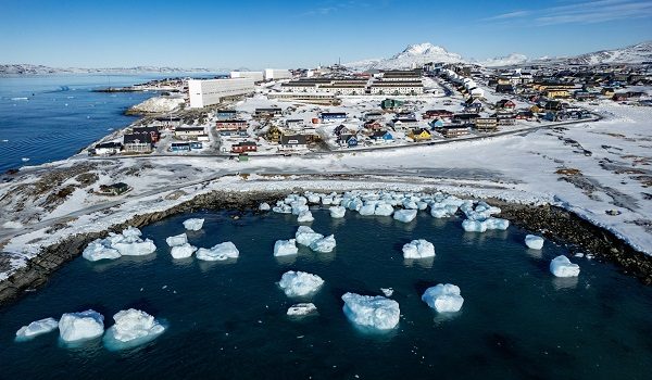 (FILES) This aerial view shows icebergs floating in the waters beaten down by the sun with buildings in the background off Nuuk, Greenland, on March 11, 2025. US President Donald Trump is discussing options including military action to take control of Greenland, the White House said on January 6, 2025, upping tensions that Denmark warns could destroy the NATO alliance. Trump has stepped up his designs on the mineral-rich, self-governing Danish territory in the arctic since the US military seized Venezuelan leader Nicolas Maduro on January 3, 2026. (Photo by Odd ANDERSEN / AFP)