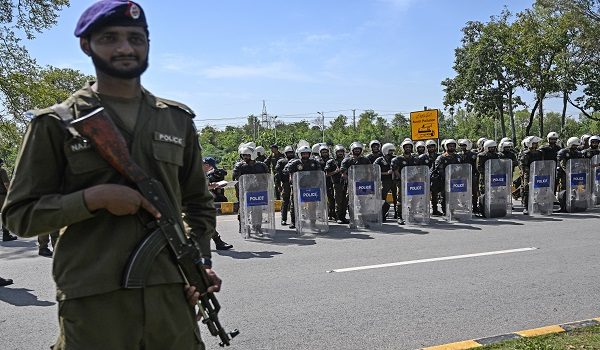 Riot policemen line up along a road near the expected venue of the US-Iran talks in the Red Zone area of Islamabad on April 10, 2026. As Iranian and US envoys prepare to hold talks in Islamabad to end the Middle East war, official sources and experts say Beijing helped pave the way for the negotiations and will be a crucial component in securing a permanent truce. (Photo by Aamir QURESHI / AFP)