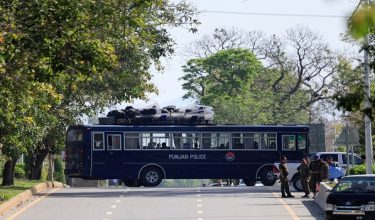 A police bus with riot gear on top moves along a road leading to the Serena hotel, as Pakistan prepares to host the U.S. and Iran for peace talks, in Islamabad, Pakistan, April 10, 2026. REUTERS/Akhtar Soomro
