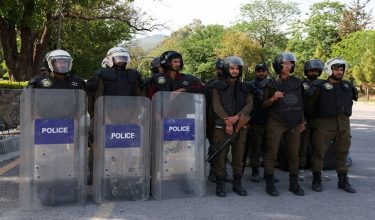 Police officers equipped with riot gear stand guard at D Chowk area, near the President's House, as Pakistan prepares to host the U.S. and Iran for peace talks, in Islamabad, Pakistan, April 10, 2026. REUTERS/Akhtar Soomro