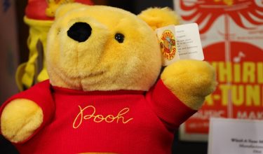 A Winnie the Pooh plush toy is displayed during a tour of the Walt Disney Studios Archive, ahead of the 100th anniversary of Winnie the Pooh, at The Walt Disney Studios in Burbank, California on February 25, 2026. Winnie the Pooh, the self-described bear of "very little brain" who has charmed generations with his homespun and heartfelt wisdom, is turning 100. Now Disney, which acquired the rights to Pooh and his pals from Hundred Acre Wood in the 1960s, is holding a year-long celebration of the slow-witted bear, whose image is found all over the planet, from Azerbaijan to Zimbabwe. (Photo by Patrick T. Fallon / AFP)