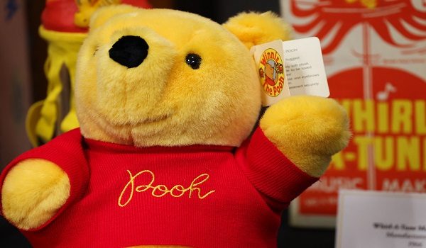 A Winnie the Pooh plush toy is displayed during a tour of the Walt Disney Studios Archive, ahead of the 100th anniversary of Winnie the Pooh, at The Walt Disney Studios in Burbank, California on February 25, 2026. Winnie the Pooh, the self-described bear of "very little brain" who has charmed generations with his homespun and heartfelt wisdom, is turning 100. Now Disney, which acquired the rights to Pooh and his pals from Hundred Acre Wood in the 1960s, is holding a year-long celebration of the slow-witted bear, whose image is found all over the planet, from Azerbaijan to Zimbabwe. (Photo by Patrick T. Fallon / AFP)