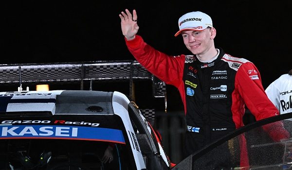 Sami Pajari of Finland waves after finishing in third place finish beside his Toyota GR Yaris Rally1 during the podium ceremony of the Rally Japan, the 13th round of the FIA World Rally Championships, in Toyota city, Aichi prefecture on November 9, 2025. (Photo by Toshifumi KITAMURA / AFP)