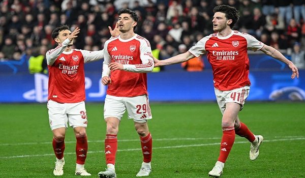 Arsenal's German midfielder #29 Kai Havertz (C) reacts after scoring from the penalty spot with his teammates Arsenal's English midfielder #41 Declan Rice (R) and Arsenal's Spanish defender #36 Martin Zubimendi during the UEFA Champions League, Last 16, first-leg football match Bayer 04 Leverkusen vs Arsenal in Leverkusen, western Germany, on March 11, 2026. (Photo by INA FASSBENDER / AFP)