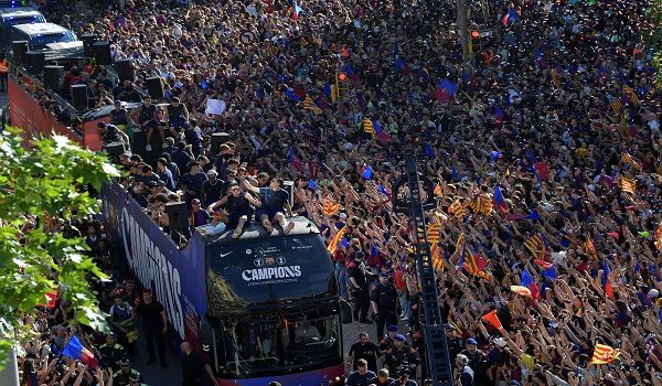 Supporters gather as Barcelona's players celebrate aboard a bus winning their 29th Spanish league title in Barcelona on May 11, 2026. Barcelona secured their 29th Spanish league title after beating Real Madrid 2-0 in the Clasico on May 10, 2026. (Photo by MANAURE QUINTERO / AFP)