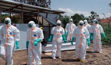 Volunteers of the Democratic Republic of Congo Red Cross wearing personal protective equipment gather around the casket containing the body of an Ebola virus disease victim from the morgue of the Rwampara health centre, before loading it into a vehicle for transfer to a cemetery as part of safe and dignified burial operations aimed at preventing the spread of the virus. The head of the World Health Organization visited Uganda on Monday and praised its efforts to limit the spread of an Ebola outbreak from neighbouring Democratic Republic of Congo. 
The WHO has declared an international health emergency over the outbreak which has caused 515 confirmed infections in the DRC, including 91 deaths, since it was announced on May 15 in northeastern DRC.
Uganda has recorded 19 cases and two deaths. All but five have been Congolese nationals who crossed the border. (Photo by Jospin Mwisha / AFP)