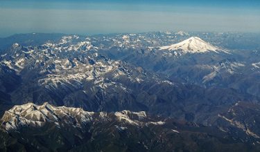 This photograph taken on October 9, 2020 shows an aerial view of the Caucasus mountains in Russia with the mount Elbrus (5642 m) in the background. (Photo by Kirill KUDRYAVTSEV / AFP)