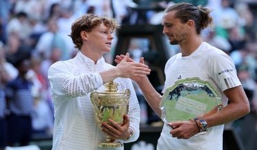 Italy's Jannik Sinner (L) holds the Gentlemen's Singles Trophy after winning the men's singles final tennis match against Germany's Alexander Zverev (R) on the last day of the 2026 Wimbledon Championships at The All England Lawn Tennis and Croquet Club in Wimbledon, southwest London, on July 12, 2026. (Photo by Henry NICHOLLS / AFP) / RESTRICTED TO EDITORIAL USE
