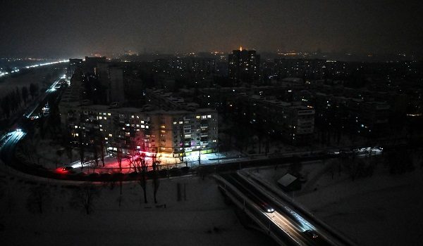 This aerial photograph shows residential area on the left bank of Dnipro River during a power outage in Kyiv on January 13, 2026, following Russian missile and drone attacks on Ukrainian energy infrastructure amid the Russian invasion in Ukraine. (Photo by Genya SAVILOV / AFP)