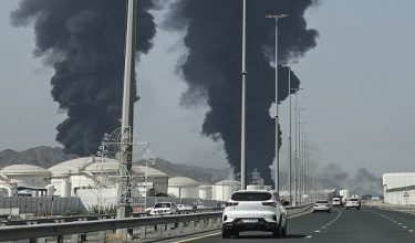 Smoke rises from the direction of an energy installation in the Gulf emirate of Fujairah on March 14, 2026. Smoke could be seen rising from the direction of a major UAE energy installation on March 14, in what appeared to be the latest strike targeting the Gulf's petroleum facilities hours after the US struck Iran's Kharg Island. (Photo by AFP) /