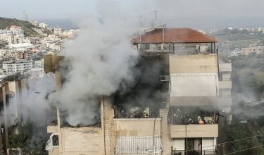 Emergency personnel work at the site of an Israeli airstrike that targeted an apartment building in the southern Lebanese town of Haret Saida, on the outskirts of Sidon, on March 14, 2026. Lebanon was drawn into the Middle East war last week when Iran-backed militant group Hezbollah attacked Israel in response to the killing of the Iranian supreme leader during US-Israeli strikes. (Photo by MAHMOUD ZAYYAT / AFP)