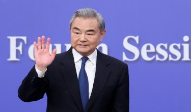 FILE PHOTO: Chinese Foreign Minister Wang Yi waves after a press conference on the sidelines of the National People's Congress (NPC), in Beijing, China, March 8, 2026. REUTERS/Maxim Shemetov/File Photo