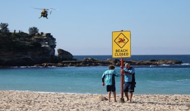 Lifeguards erect a sign that says "Beach Closed" following a shark attack at Coogee Beach in Sydney, Australia, June 13, 2026. REUTERS/Hollie Adams
