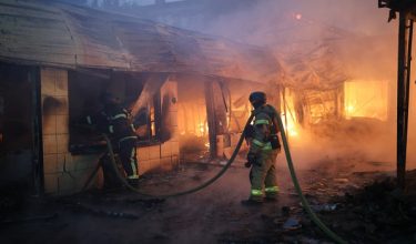 Firefighters put out a blaze at a market during the Russian missile strike on the Ukrainian capital of Kyiv on June 15, 2026, amid the Russian invasion in Ukraine. A major missile attack struck Kyiv early on June 15, an AFP reporter witnessed, with projectiles intercepted in the sky and glowing debris falling onto the city. Ukrainian officials including the city's mayor Vitali Klitschko reported on Telegram that strikes hit various districts. (Photo by Serhii Okunev / AFP)