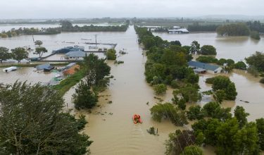 An aerial photo taken on February 14, 2023 shows flooding caused by Cyclone Gabrielle in Awatoto, near the city of Napier. New Zealand declared a national state of emergency on February 14 as Cyclone Gabrielle swept away roads, inundated homes and left more than 100,000 people without power. (Photo by AFP) / New Zealand OUT / NEW ZEALAND OUT