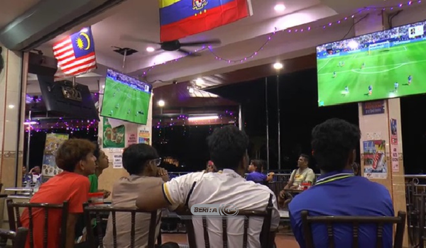 Peminat bola sepak menyaksikan perlawanan Piala Dunia