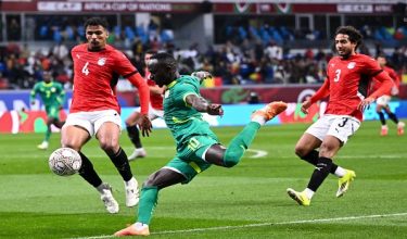 Egypt's defender #4 Hossam Abdelmaguid, Senegal's forward #10 Sadio Mane and Egypt's defender #03 Mohamed Hany vie during the Africa Cup of Nations (CAN) semi-final football match between Senegal and Egypt at the Grand stadium in Tangiers on January 14, 2026. (Photo by SEBASTIEN BOZON / AFP)